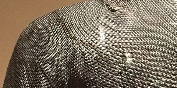 Closeup of a chainmail shirt to show how the grain flows from the body into the sleeve.